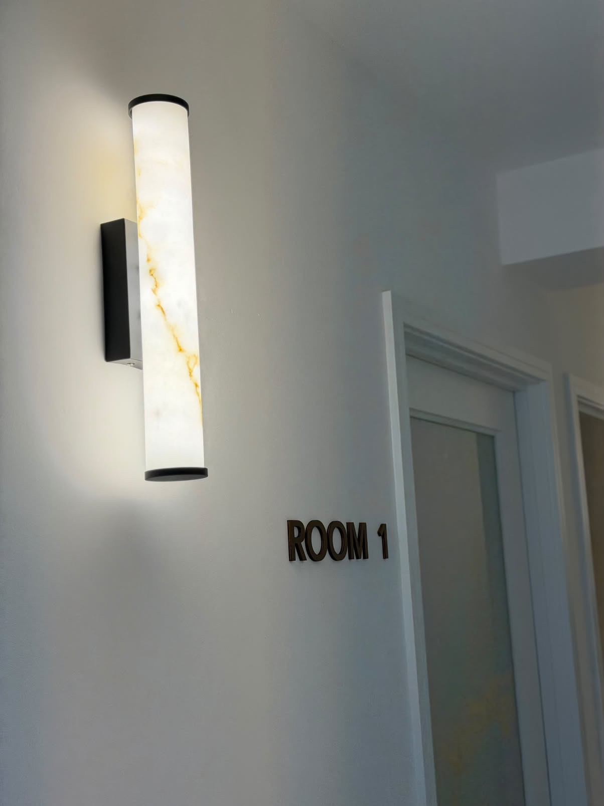Room 1 entrance with a glowing marble-effect wall light