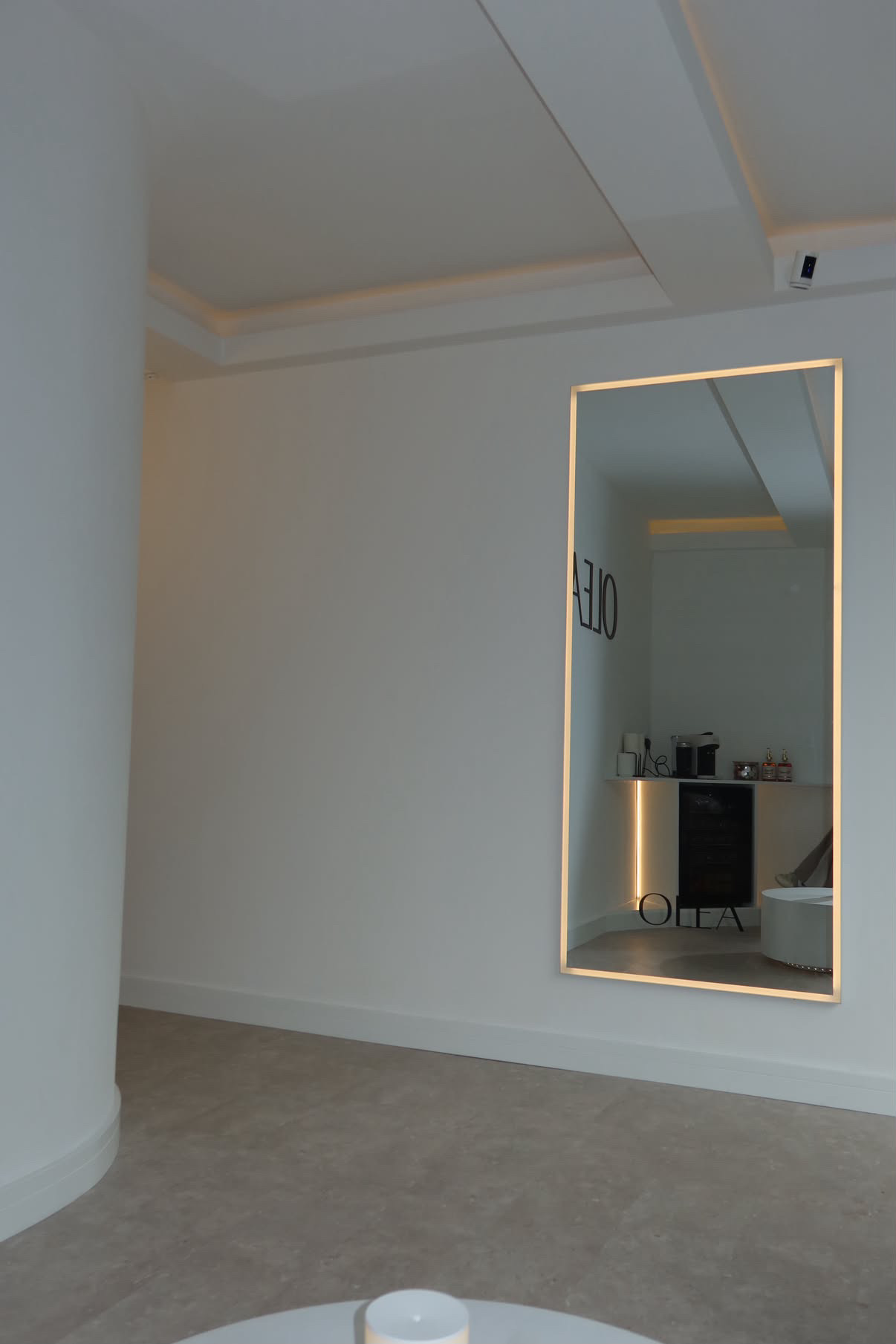 A light-filled OLÉA interior with a large illuminated mirror